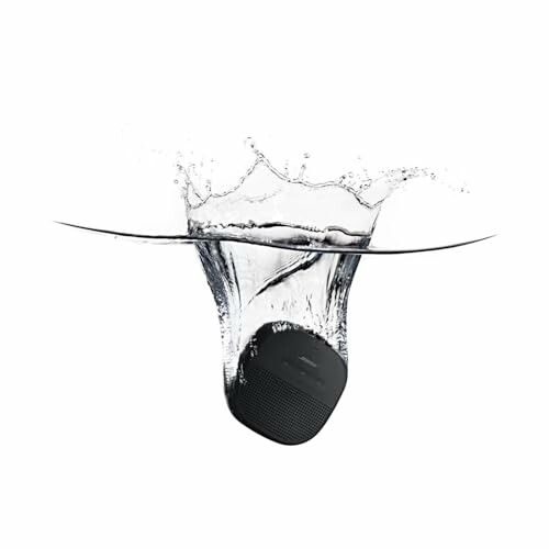 Black portable speaker splashing into water.