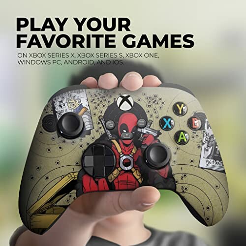Custom Xbox controller with superhero design held in hand.