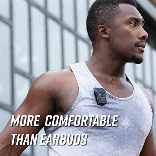 Man wearing a gray tank top with a wireless clip-on speaker.