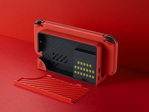 Red gaming console with open back cover and compartment