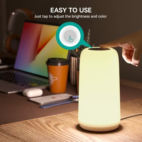 Touch lamp on desk with laptop and coffee cup.